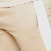 Close-up of custom workout shorts. Breathable fabric, reinforced stitching, subtle logo placement. Performance activewear, da