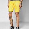 Recycled fabric shorts, close-up showing textured weave, neat stitching. Green hue hints at eco-friendly material. Sustainabl