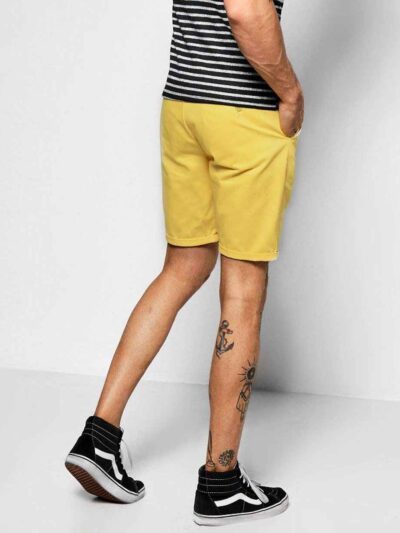 Recycled fabric shorts, close-up showing textured weave, neat stitching. Green hue hints at eco-friendly material. Sustainabl