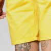 Recycled fabric shorts, close-up showing textured weave, neat stitching. Green hue hints at eco-friendly material. Sustainabl