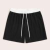 Close-up of athletic shorts, charcoal grey with a subtle textured weave. Notice reinforced stitching & built-in compression l