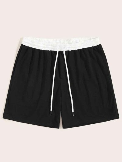 Close-up of athletic shorts, charcoal grey with a subtle textured weave. Notice reinforced stitching & built-in compression l