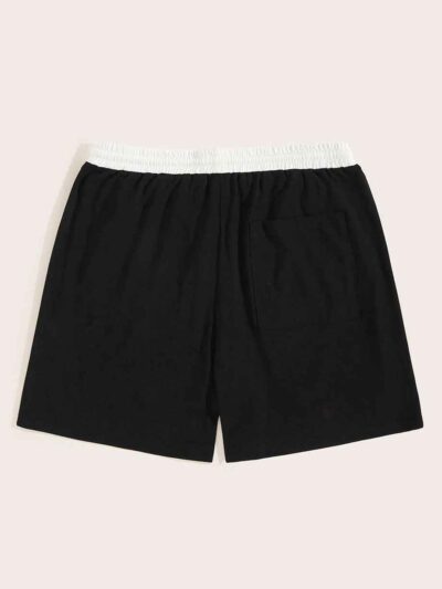 Close-up of athletic shorts, charcoal grey with a subtle textured weave. Notice reinforced stitching & built-in compression l