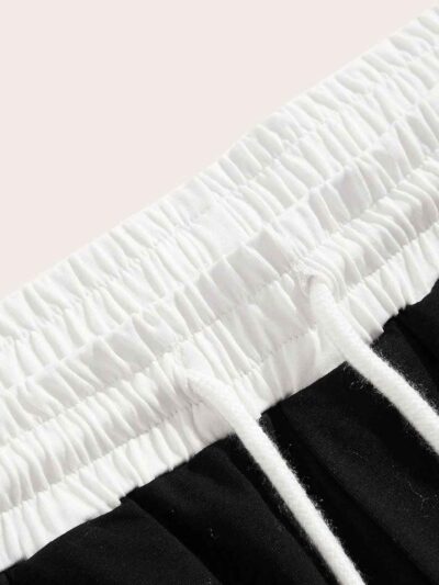 Close-up of athletic shorts, charcoal grey with a subtle textured weave. Notice reinforced stitching & built-in compression l
