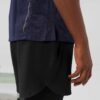 Men's high-end streetwear short set. Textured fabric, subtle stitching, tailored fit. Two-piece design, likely breathable mat