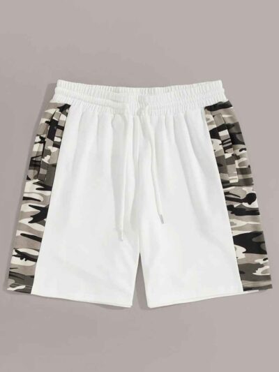 Oversized baggy streetwear shorts. Heavyweight cotton twill, visible stitching details. Neutral tone, industrial aesthetic. -