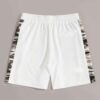 Oversized baggy streetwear shorts. Heavyweight cotton twill, visible stitching details. Neutral tone, industrial aesthetic. -