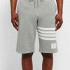 Performance athletic shorts, black with silver reflective trim. Close-up shows breathable, textured fabric and reinforced sti