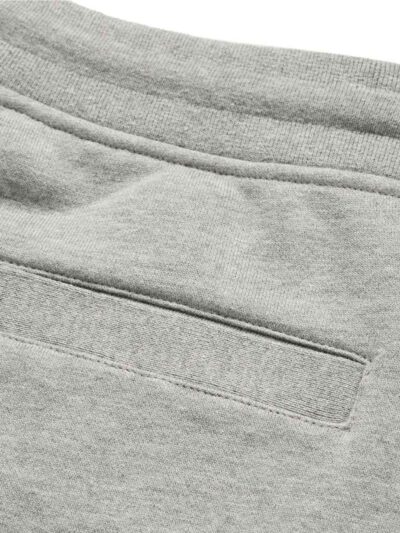 Performance athletic shorts, black with silver reflective trim. Close-up shows breathable, textured fabric and reinforced sti