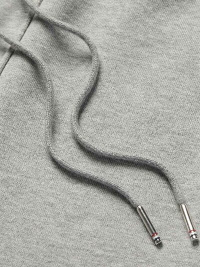 Performance athletic shorts, black with silver reflective trim. Close-up shows breathable, textured fabric and reinforced sti
