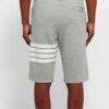 Performance athletic shorts, black with silver reflective trim. Close-up shows breathable, textured fabric and reinforced sti