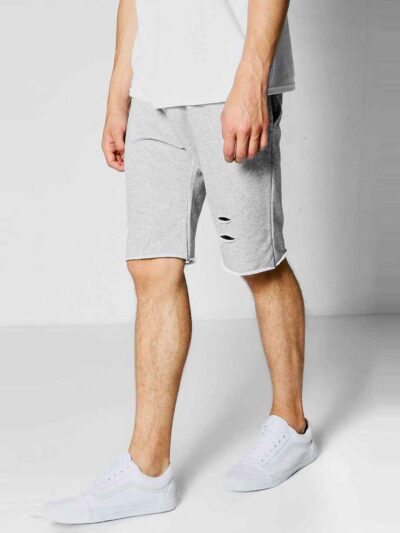 Close-up of athletic shorts fabric. Visible moisture-wicking weave, reinforced stitching. Performance garment in neutral gray