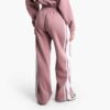 Women's two-piece tracksuit set, likely fleece or terry knit. Custom neck label detail. Athleisure wear, comfy fit, relaxed s