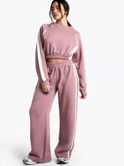 Women's two-piece tracksuit set, likely fleece or terry knit. Custom neck label detail. Athleisure wear, comfy fit, relaxed s