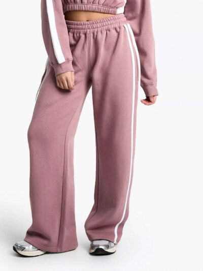 Women's two-piece tracksuit set, likely fleece or terry knit. Custom neck label detail. Athleisure wear, comfy fit, relaxed s