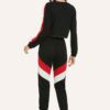 Stylish quarter zip top and contrast striped pants. Soft knit texture, clean stitching, subtle color accents on zip and strip