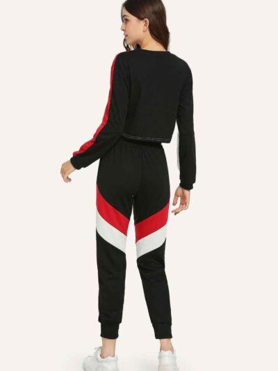 Stylish quarter zip top and contrast striped pants. Soft knit texture, clean stitching, subtle color accents on zip and strip