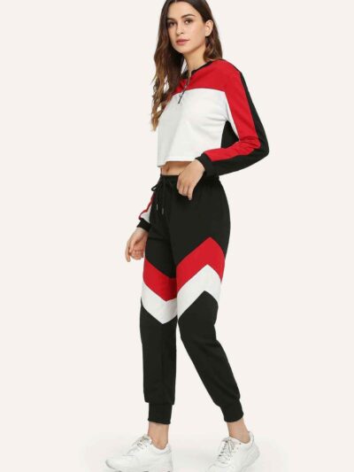 Stylish quarter zip top and contrast striped pants. Soft knit texture, clean stitching, subtle color accents on zip and strip
