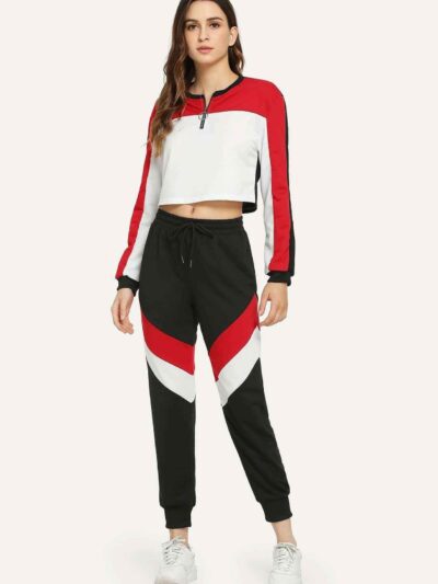 Stylish quarter zip top and contrast striped pants. Soft knit texture, clean stitching, subtle color accents on zip and strip