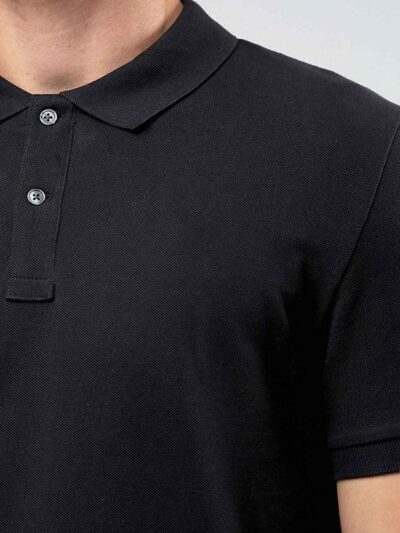 Close-up of a navy polo shirt. Smooth, breathable polyester with fine stitching. Custom logo printed sharply on the chest. -
