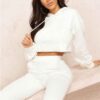 Heather gray crop hoodie with visible raw hem and intricate seam detailing. Soft, slightly textured fabric. Custom stitching