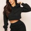 Heather gray crop hoodie with visible raw hem and intricate seam detailing. Soft, slightly textured fabric. Custom stitching