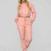 Long, relaxed-fit sweatsuit set in soft heather gray. Drawstring tie at waist, visible stitching details, comfortable knit fa