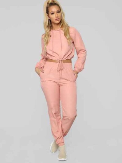 Long, relaxed-fit sweatsuit set in soft heather gray. Drawstring tie at waist, visible stitching details, comfortable knit fa