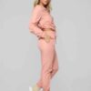 Long, relaxed-fit sweatsuit set in soft heather gray. Drawstring tie at waist, visible stitching details, comfortable knit fa