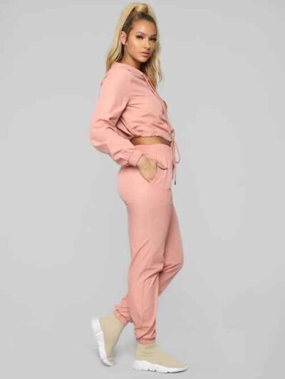 Long, relaxed-fit sweatsuit set in soft heather gray. Drawstring tie at waist, visible stitching details, comfortable knit fa