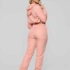 Long, relaxed-fit sweatsuit set in soft heather gray. Drawstring tie at waist, visible stitching details, comfortable knit fa