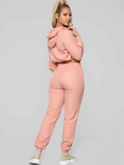 Long, relaxed-fit sweatsuit set in soft heather gray. Drawstring tie at waist, visible stitching details, comfortable knit fa
