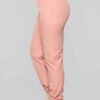 Long, relaxed-fit sweatsuit set in soft heather gray. Drawstring tie at waist, visible stitching details, comfortable knit fa