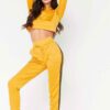 Cropped tracksuit in soft-touch knit fabric. Side stripe detail. Sporty-casual style with clean stitching, hints of vibrant c