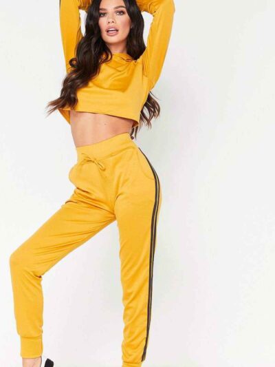 Cropped tracksuit in soft-touch knit fabric. Side stripe detail. Sporty-casual style with clean stitching, hints of vibrant c