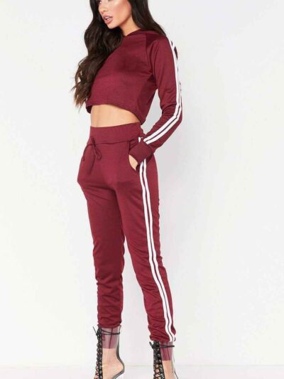 Cropped tracksuit in soft-touch knit fabric. Side stripe detail. Sporty-casual style with clean stitching, hints of vibrant c