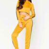 Cropped tracksuit in soft-touch knit fabric. Side stripe detail. Sporty-casual style with clean stitching, hints of vibrant c