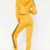 Cropped tracksuit in soft-touch knit fabric. Side stripe detail. Sporty-casual style with clean stitching, hints of vibrant c