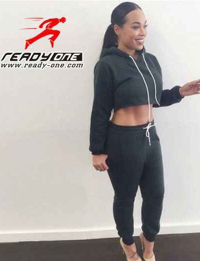 Slim fit ladies' sweatsuit: cropped top, high-waisted pants. Soft knit fabric with fine stitching. Mauve pink hue, comfortabl