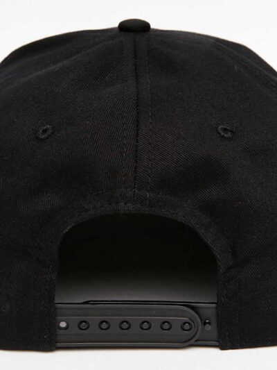 Black snapback cap. Close-up reveals tight stitching, structured crown, and matte texture. Adjustable fit, flat brim, urban s