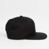 Black snapback cap. Close-up reveals tight stitching, structured crown, and matte texture. Adjustable fit, flat brim, urban s