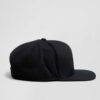 Structured canvas snapback cap. Flat brim, visible stitching detail. Adjustable back closure. Modern streetwear style. - View