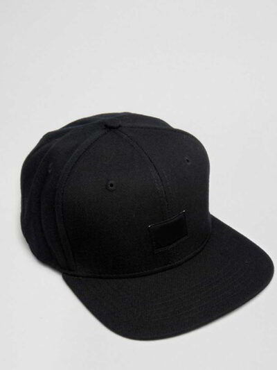 Structured canvas snapback cap. Flat brim, visible stitching detail. Adjustable back closure. Modern streetwear style. - View