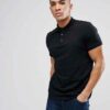 Close-up of a soft cotton polo shirt; subtle pique texture, neat stitching. Perfect casual wear, shown in a light, neutral co