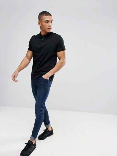 Close-up of a soft cotton polo shirt; subtle pique texture, neat stitching. Perfect casual wear, shown in a light, neutral co