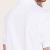 Close-up of a textured cotton polo shirt with visible breathable weave and reinforced stitching. Sportswear in a subtle shade