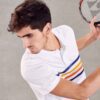 Close-up of a textured cotton polo shirt with visible breathable weave and reinforced stitching. Sportswear in a subtle shade