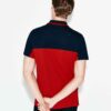 Close-up of a polo shirt with stylish color blocking and a prominent neck label. Textured fabric with visible, quality stitch