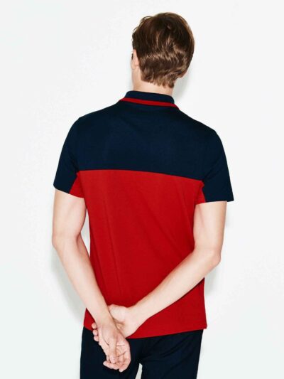 Close-up of a polo shirt with stylish color blocking and a prominent neck label. Textured fabric with visible, quality stitch
