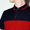 Close-up of a polo shirt with stylish color blocking and a prominent neck label. Textured fabric with visible, quality stitch